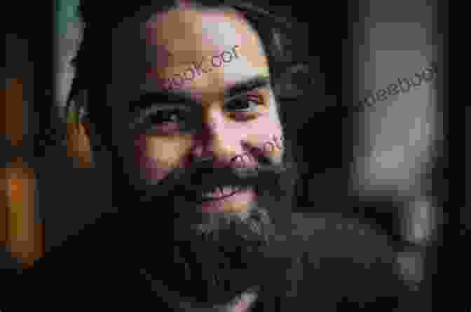 Portrait Of Roger Grant, A Bearded Man With Kind Eyes And A Warm Smile, Holding A Needle And Thread In His Hands. Angel Ornaments Cross Stitch H Roger Grant